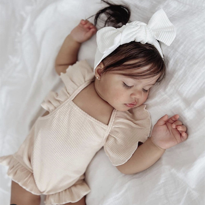 Baby girl solid color sleeveless square neck onesies in white, pink, and khaki, showcasing elegant design and soft cotton fabric.