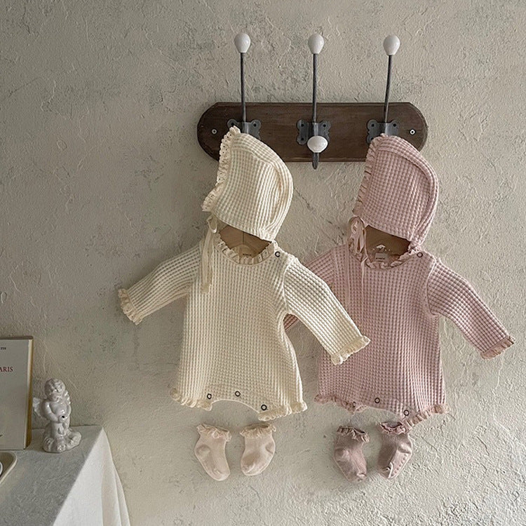 Baby girl bodysuit in solid color with waffle pattern and lace design, featuring long sleeves and triangle cut.