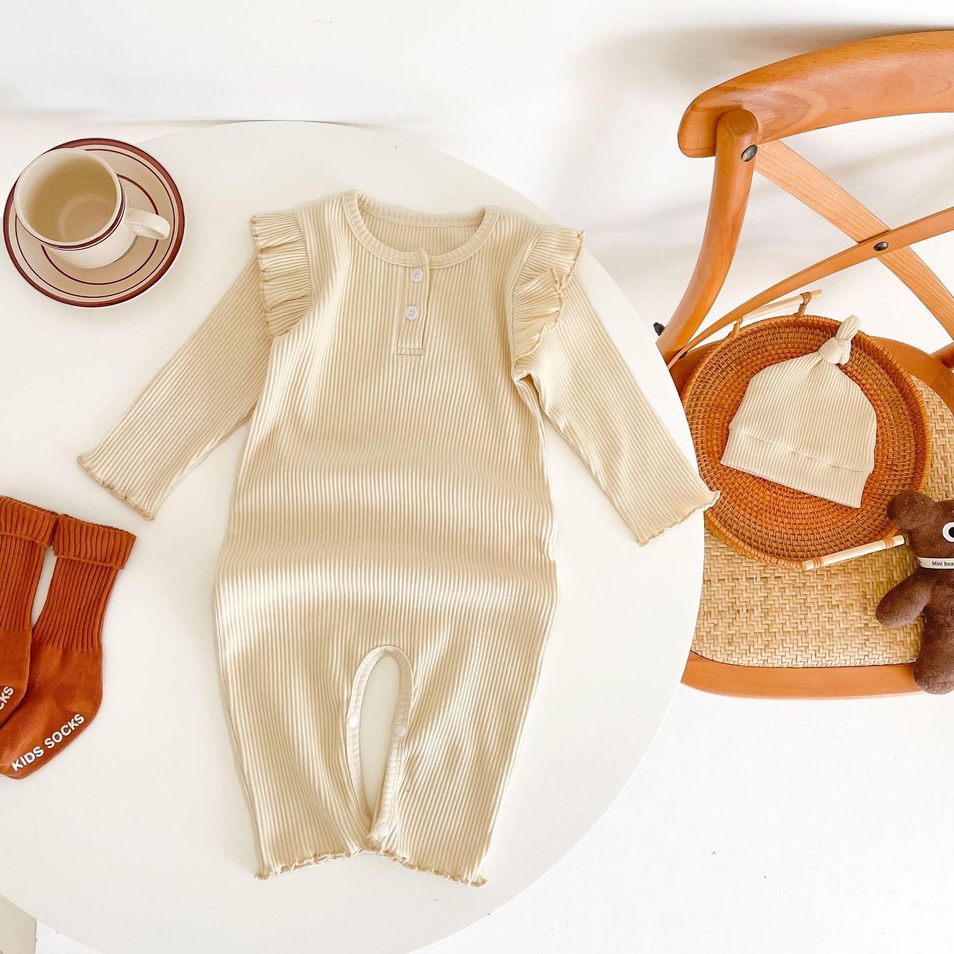 Baby girl solid pit bar long romper in purple with matching hat, showcasing a stylish long silhouette made from soft cotton fabric.