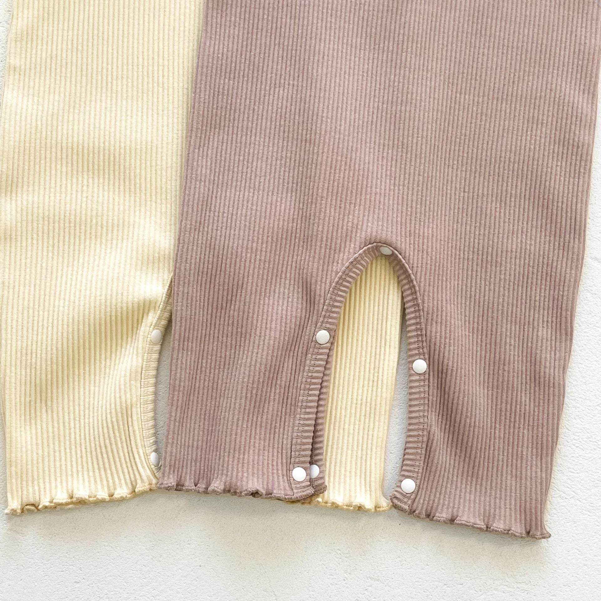 Baby girl solid pit bar long romper in purple with matching hat, showcasing a stylish long silhouette made from soft cotton fabric.