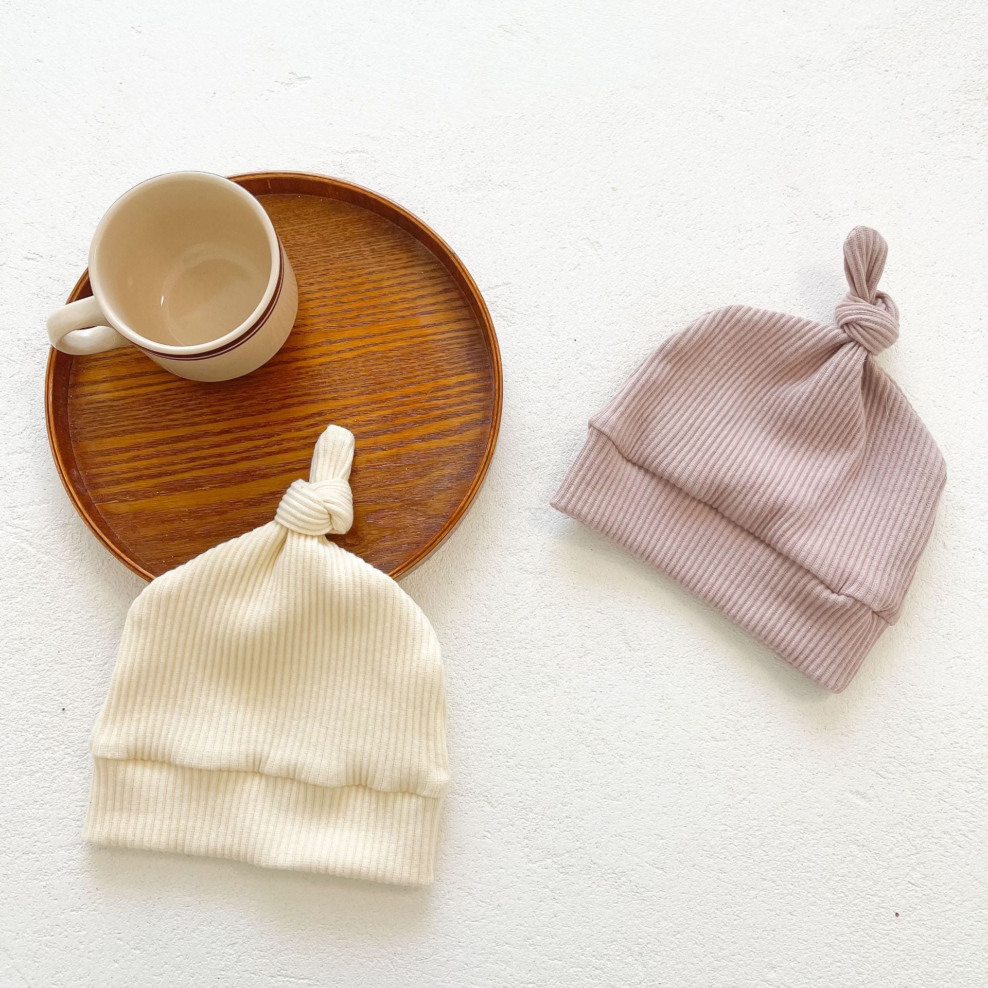 Baby girl solid pit bar long romper in purple with matching hat, showcasing a stylish long silhouette made from soft cotton fabric.