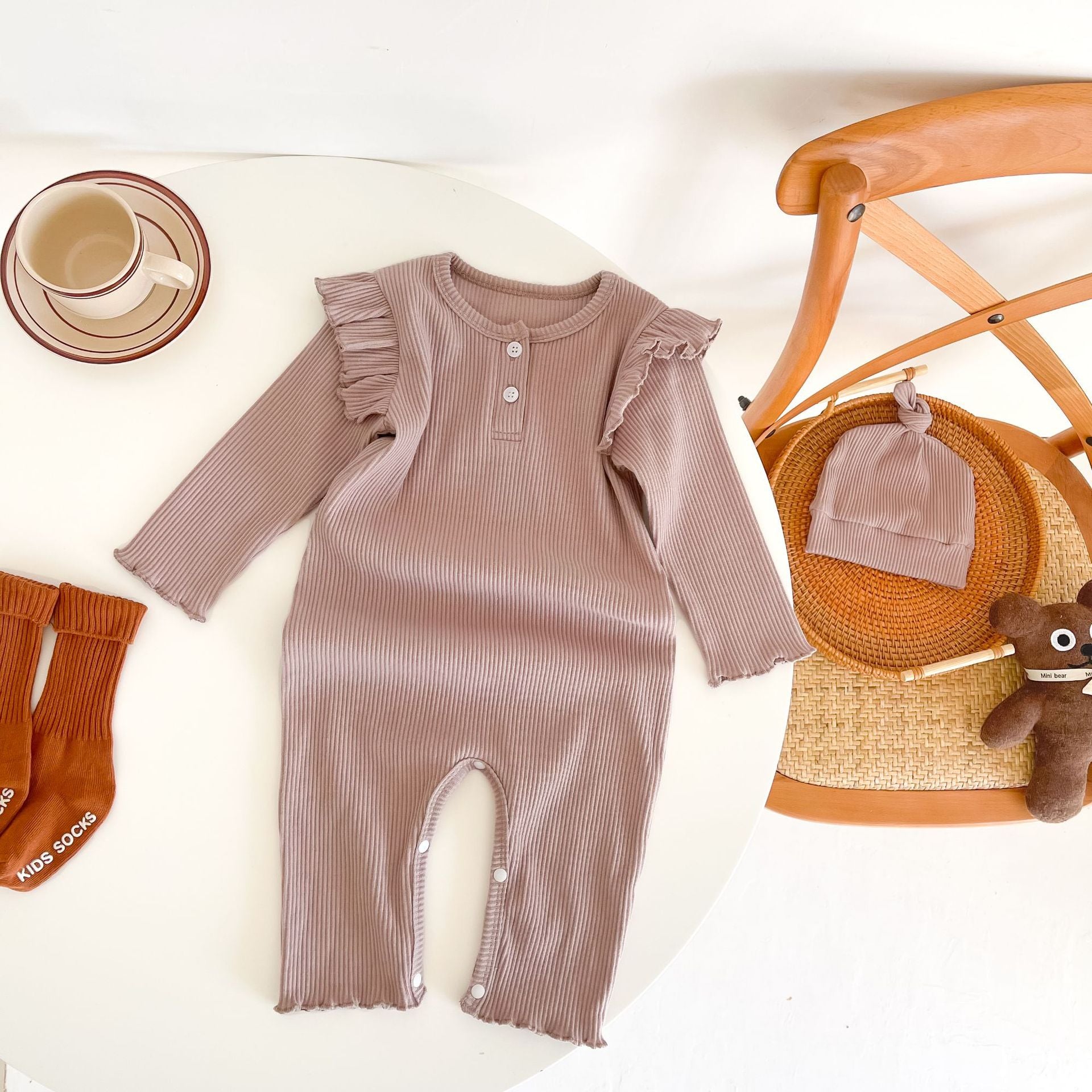 Baby girl solid pit bar long romper in purple with matching hat, showcasing a stylish long silhouette made from soft cotton fabric.