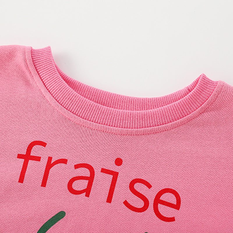 Baby girl wearing a strawberry print pattern crewneck terry hoodie in pink, showcasing a vibrant and playful design.