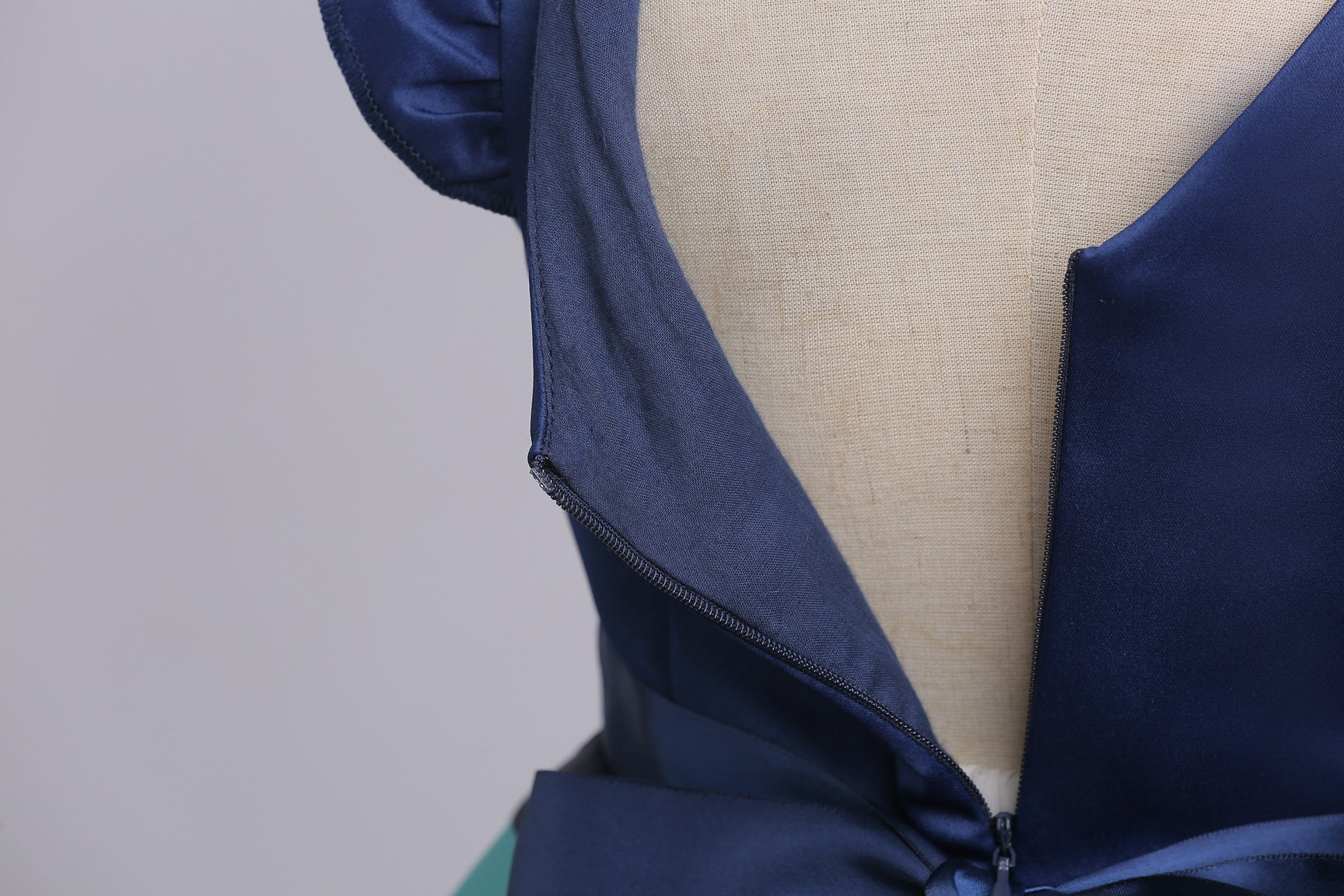 Baby girl wearing a striped pattern V-neck western style formal dress in vibrant colors, perfect for summer occasions.