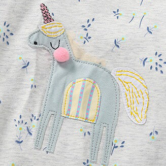 Baby girl wearing a unicorn and floral patterned mesh patchwork hoodie, showcasing vibrant colors and a playful design.