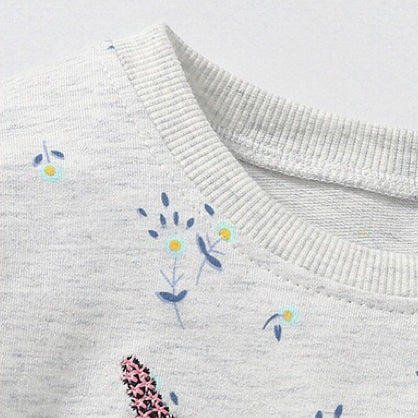 Baby girl wearing a unicorn and floral patterned mesh patchwork hoodie, showcasing vibrant colors and a playful design.