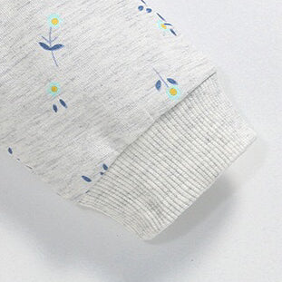 Baby girl wearing a unicorn and floral patterned mesh patchwork hoodie, showcasing vibrant colors and a playful design.