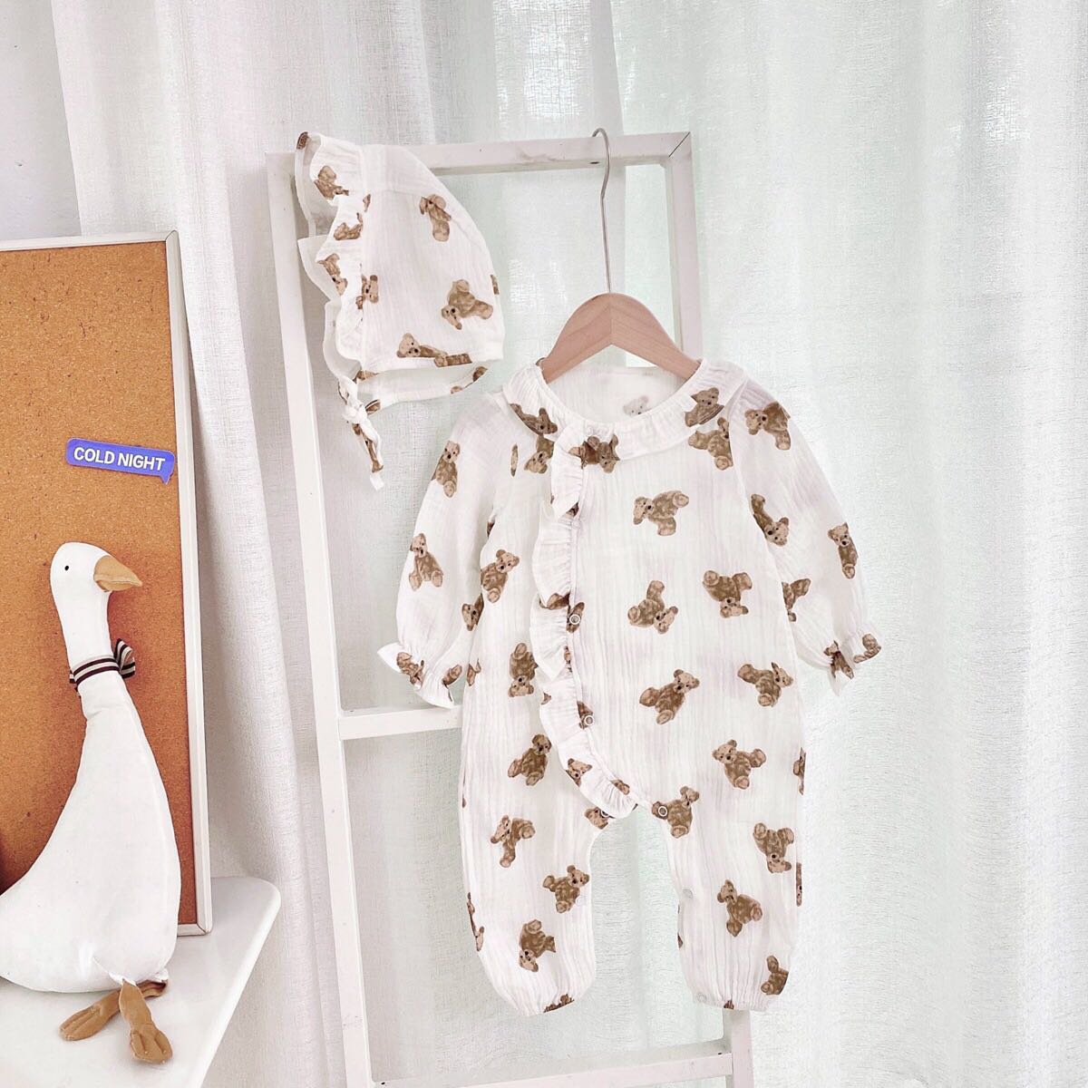 Baby girls' romper featuring bear print pattern and lace design, round collar, and long sleeves, perfect for stylish infants.