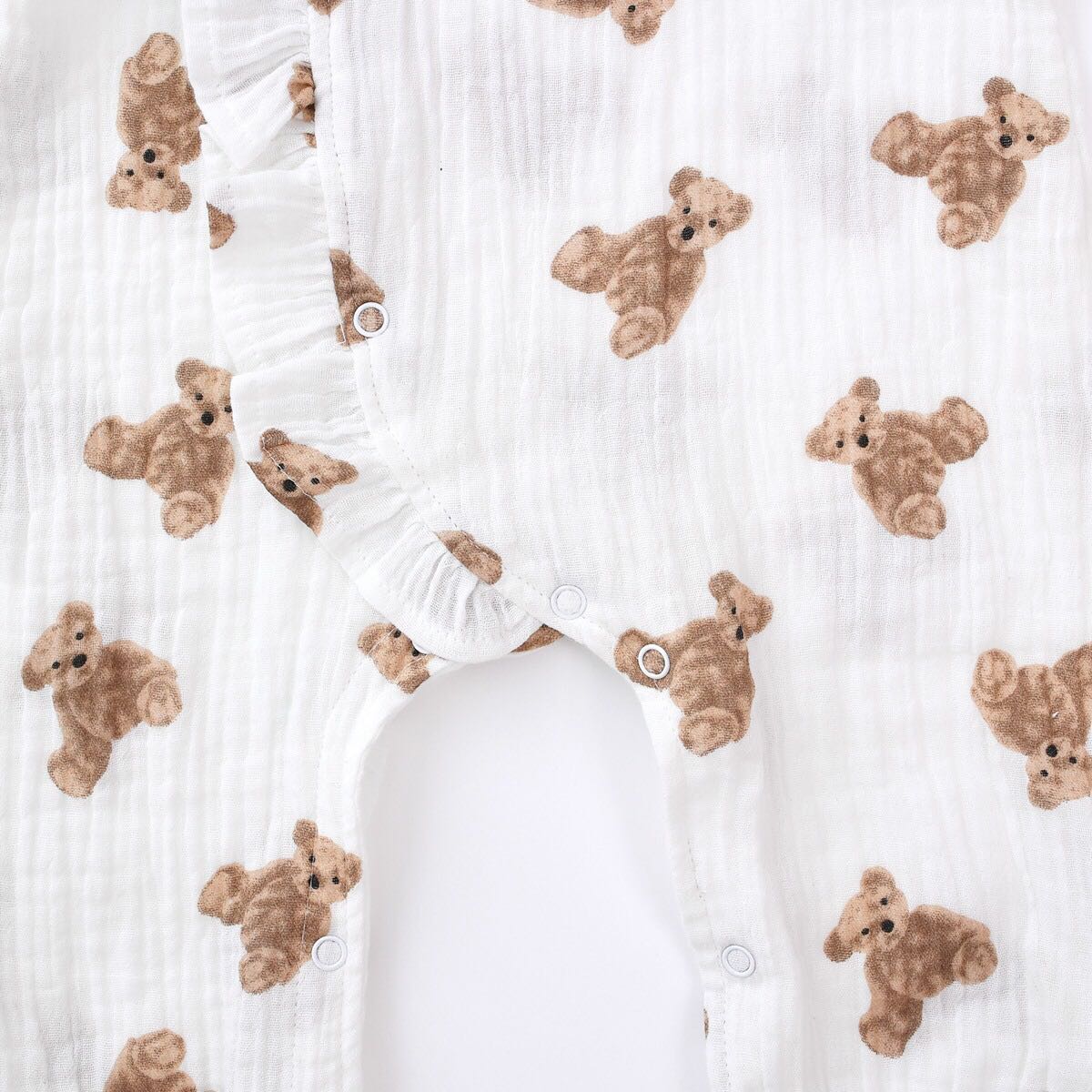 Baby girls' romper featuring bear print pattern and lace design, round collar, and long sleeves, perfect for stylish infants.