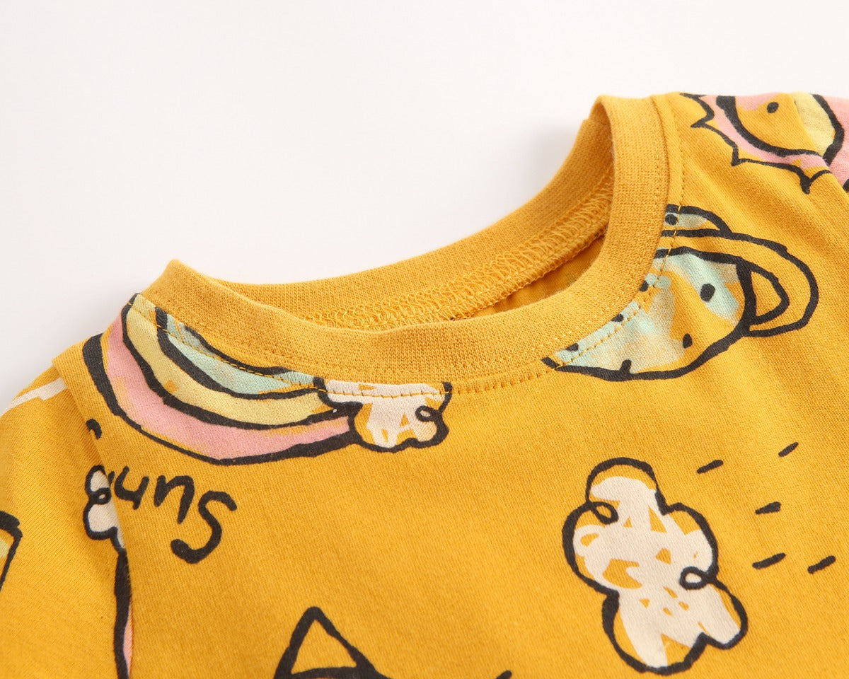 A bright yellow baby girl's dress featuring a cartoon print with animals and rainbows, perfect for summer wear.