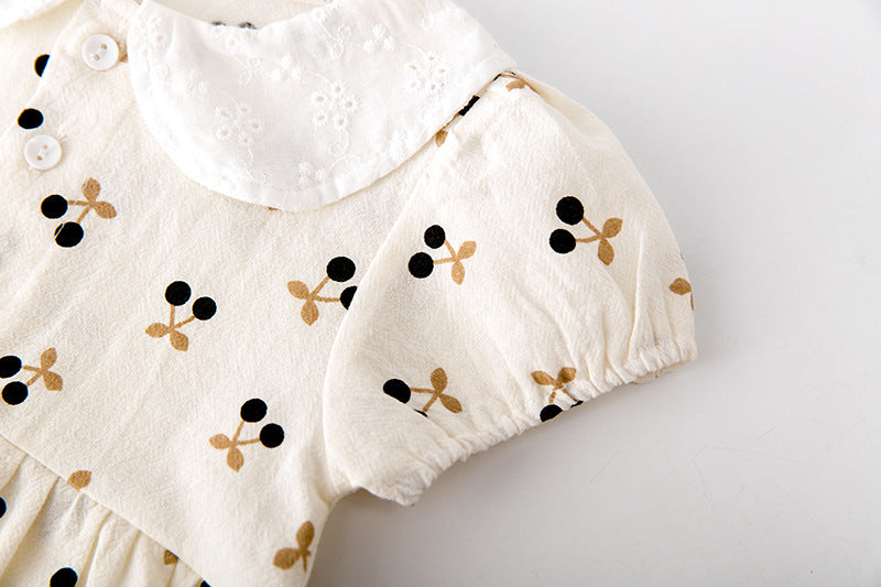 Baby girls cherry print onesie featuring a doll collar and puff sleeves in apricot color.