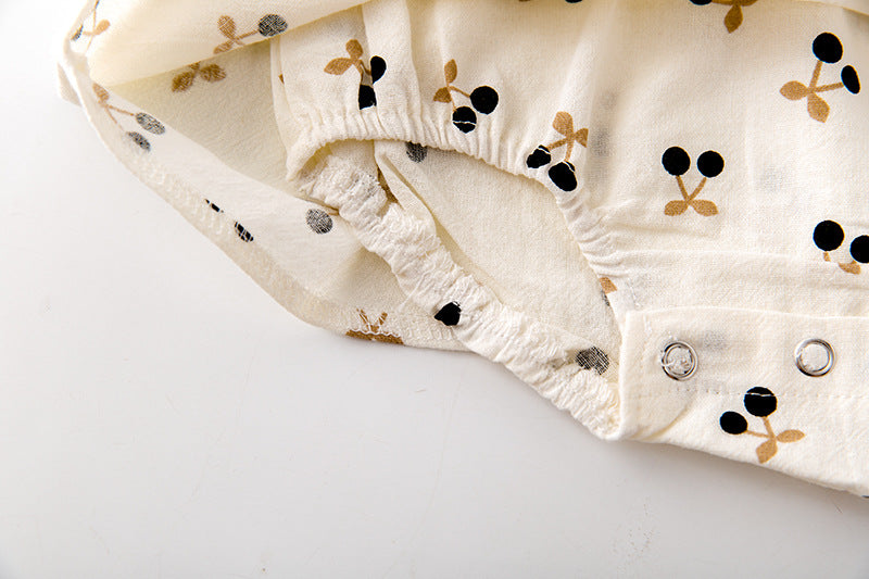 Baby girls cherry print onesie featuring a doll collar and puff sleeves in apricot color.