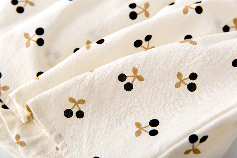 Baby girls cherry print onesie featuring a doll collar and puff sleeves in apricot color.