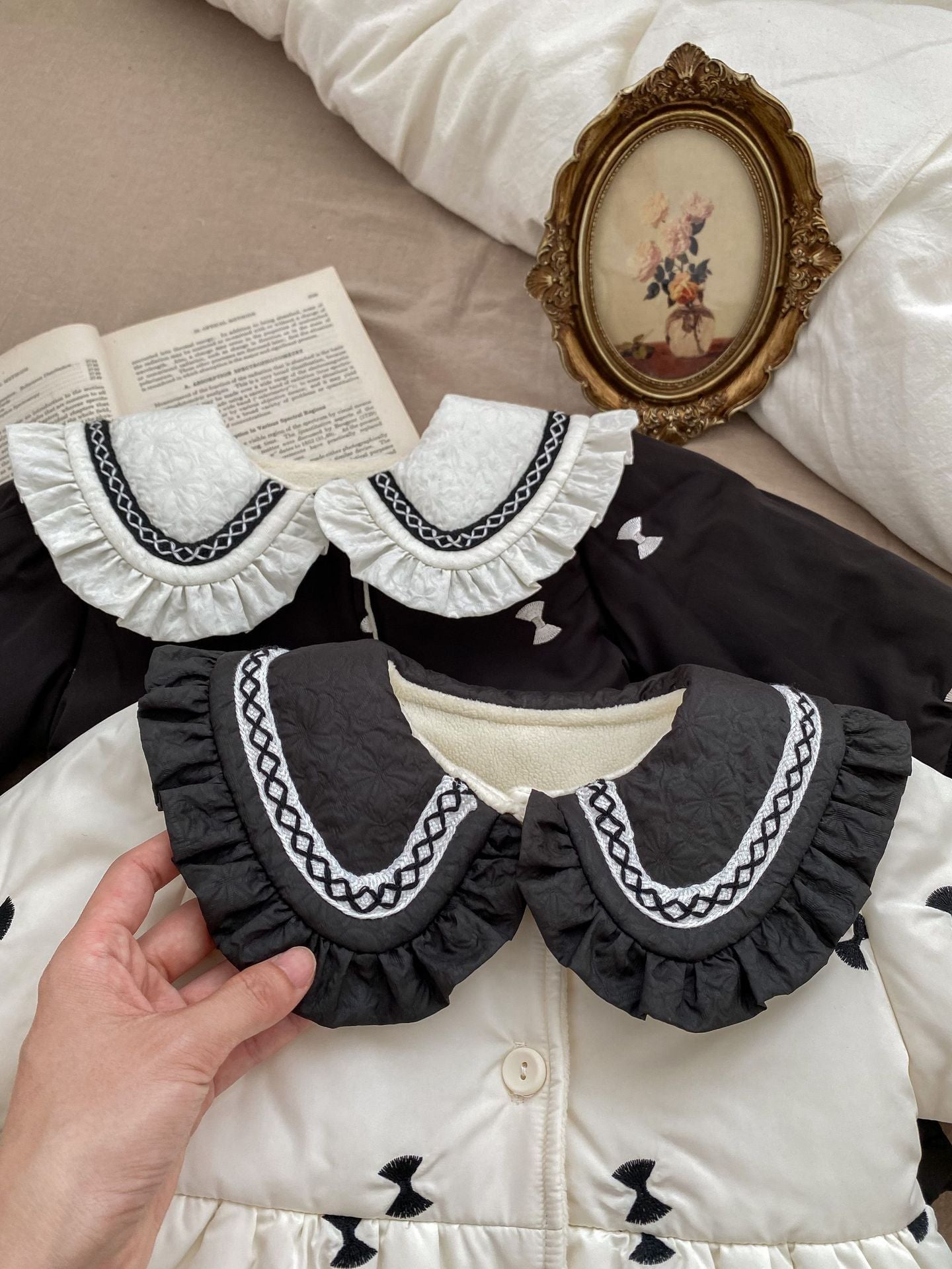 Baby girls' winter coat in blue and beige with floral pattern, made from soft cotton and polyester blend.