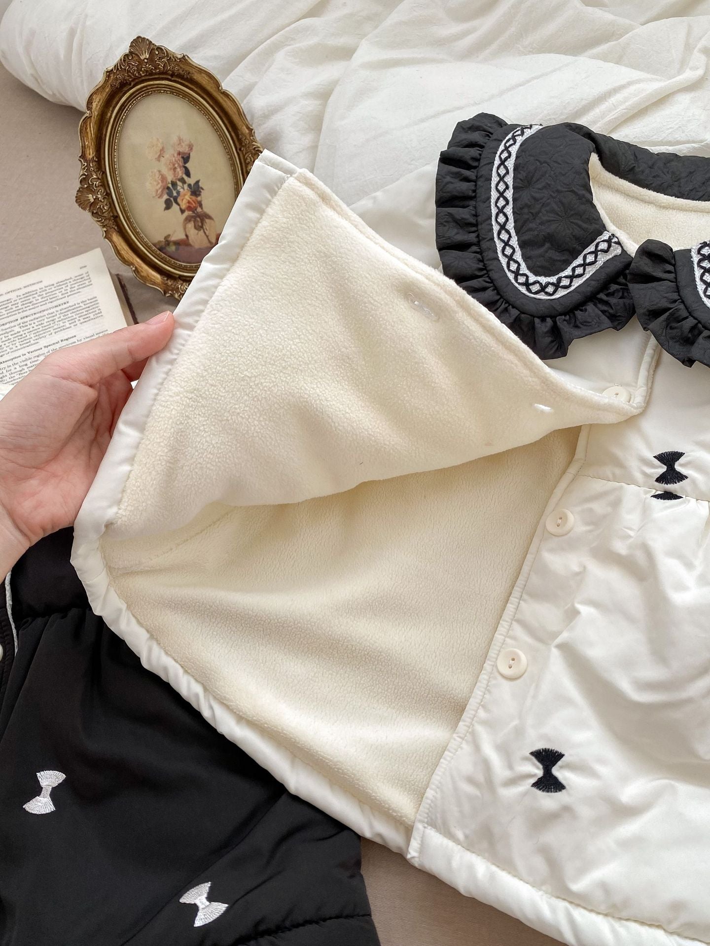 Baby girls' winter coat in blue and beige with floral pattern, made from soft cotton and polyester blend.