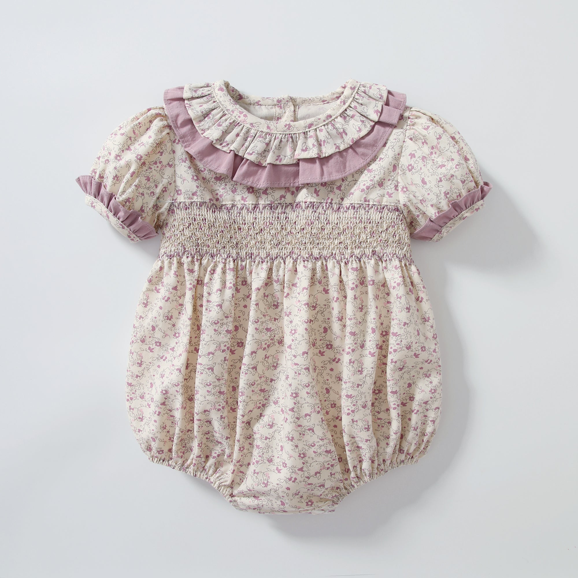 Baby girl wearing a floral print doll collar onesie with a matching headband, showcasing a stylish summer outfit.