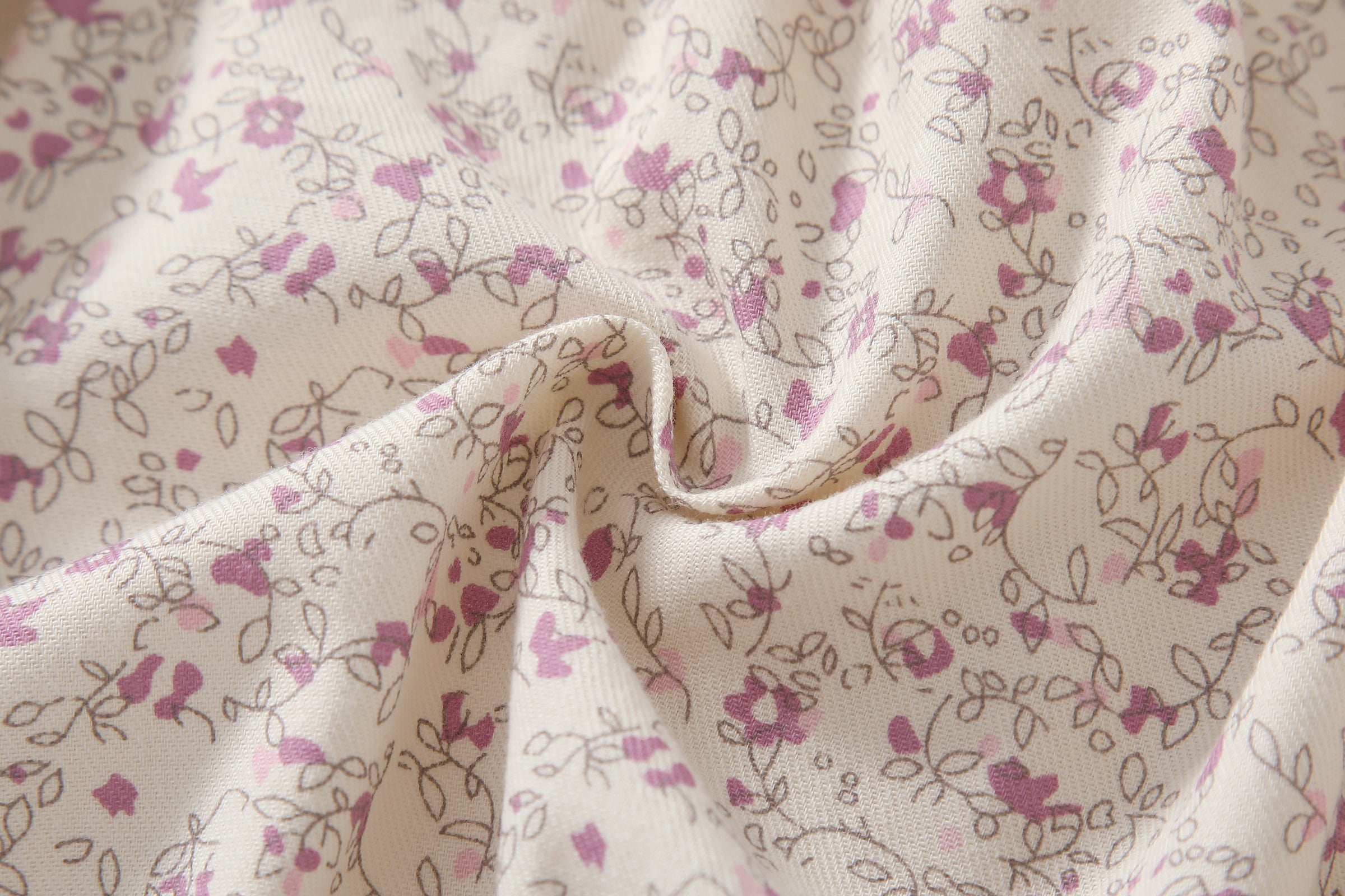 Baby girl wearing a floral print doll collar onesie with a matching headband, showcasing a stylish summer outfit.