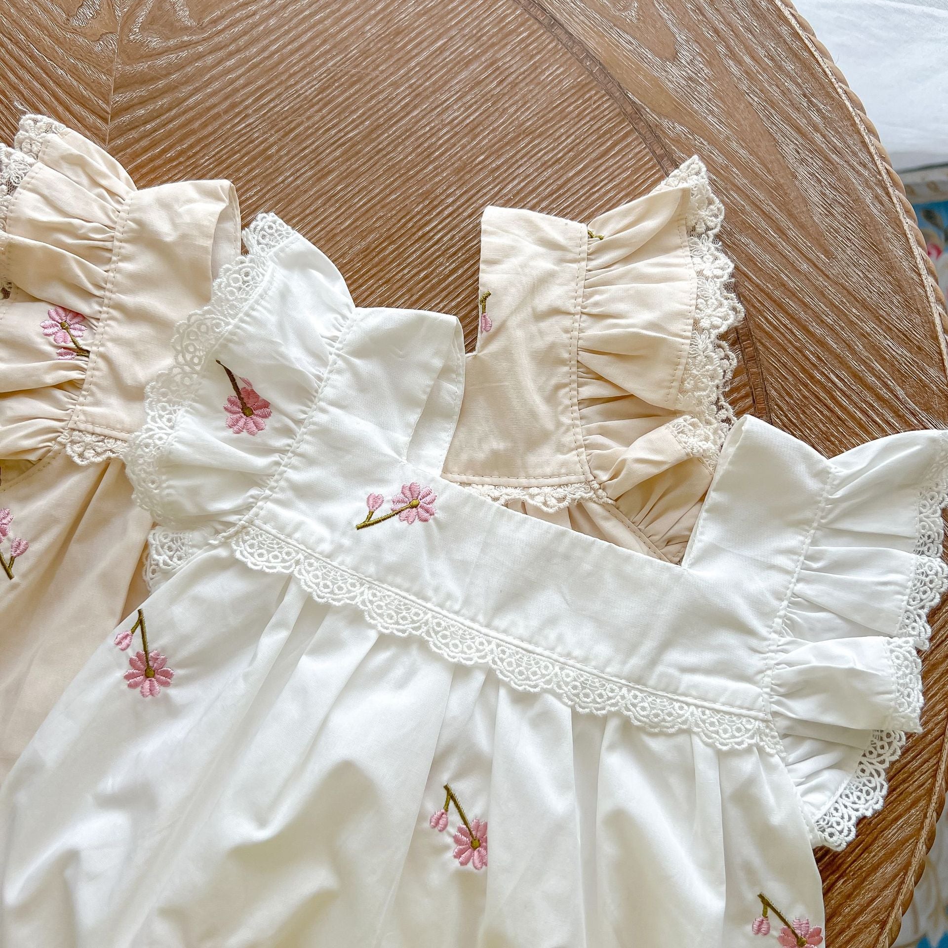 Baby girls floral print ruffle design square-collar summer cotton onesie in white and apricot colors, showcasing a stylish floral pattern.