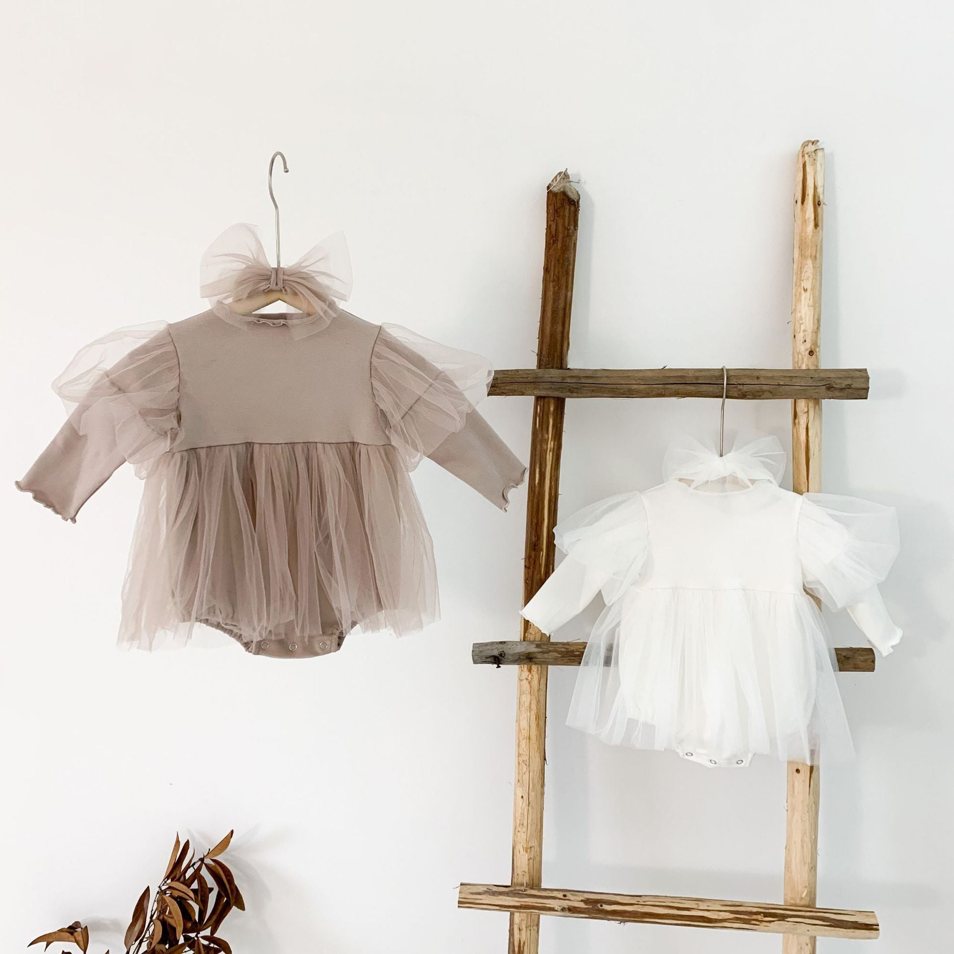 Baby girls' lace patchwork bubble dress in white with long sleeves, showcasing delicate lace details and a comfortable fit.