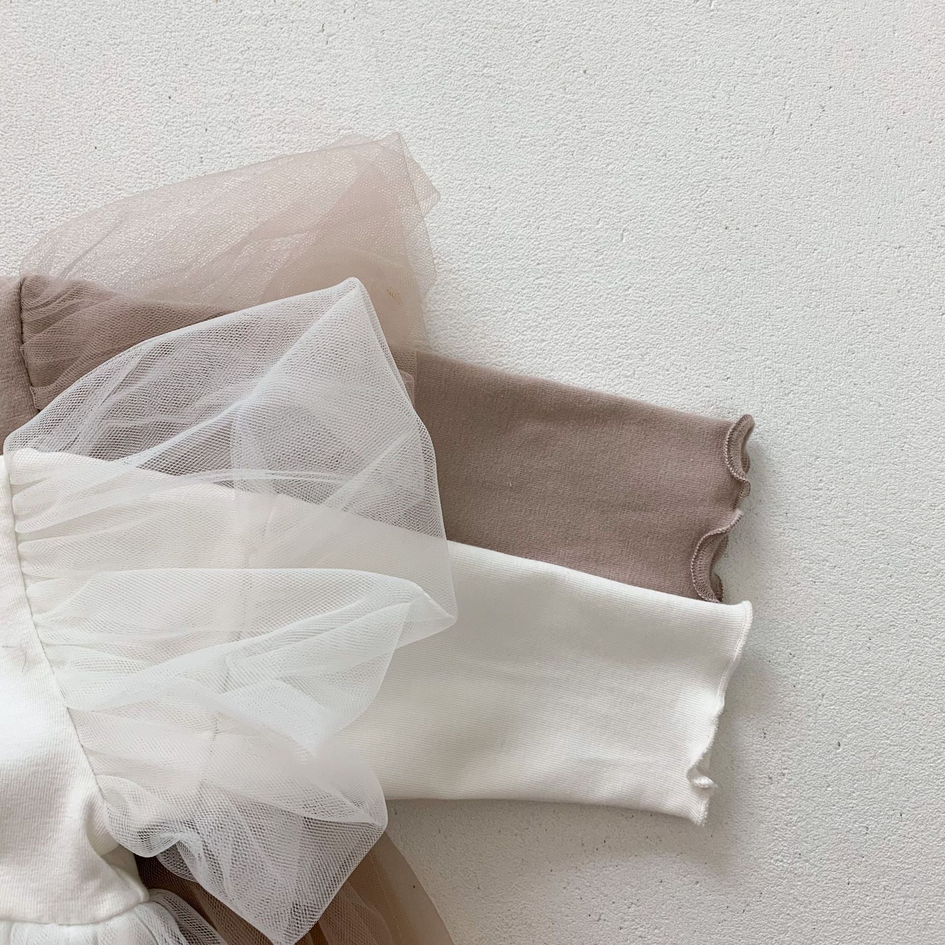 Baby girls' lace patchwork bubble dress in white with long sleeves, showcasing delicate lace details and a comfortable fit.