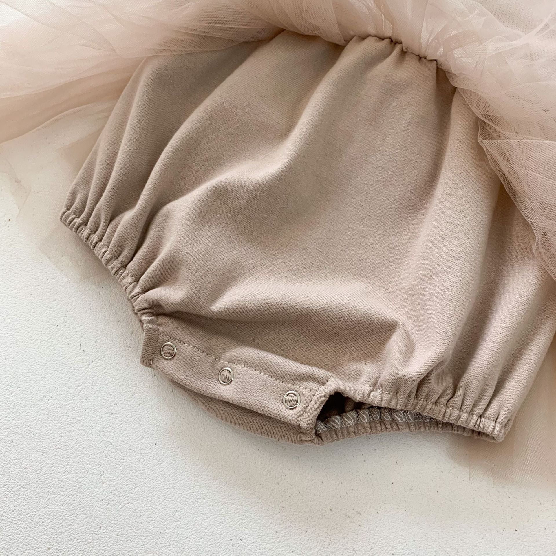 Baby girls' lace patchwork bubble dress in white with long sleeves, showcasing delicate lace details and a comfortable fit.