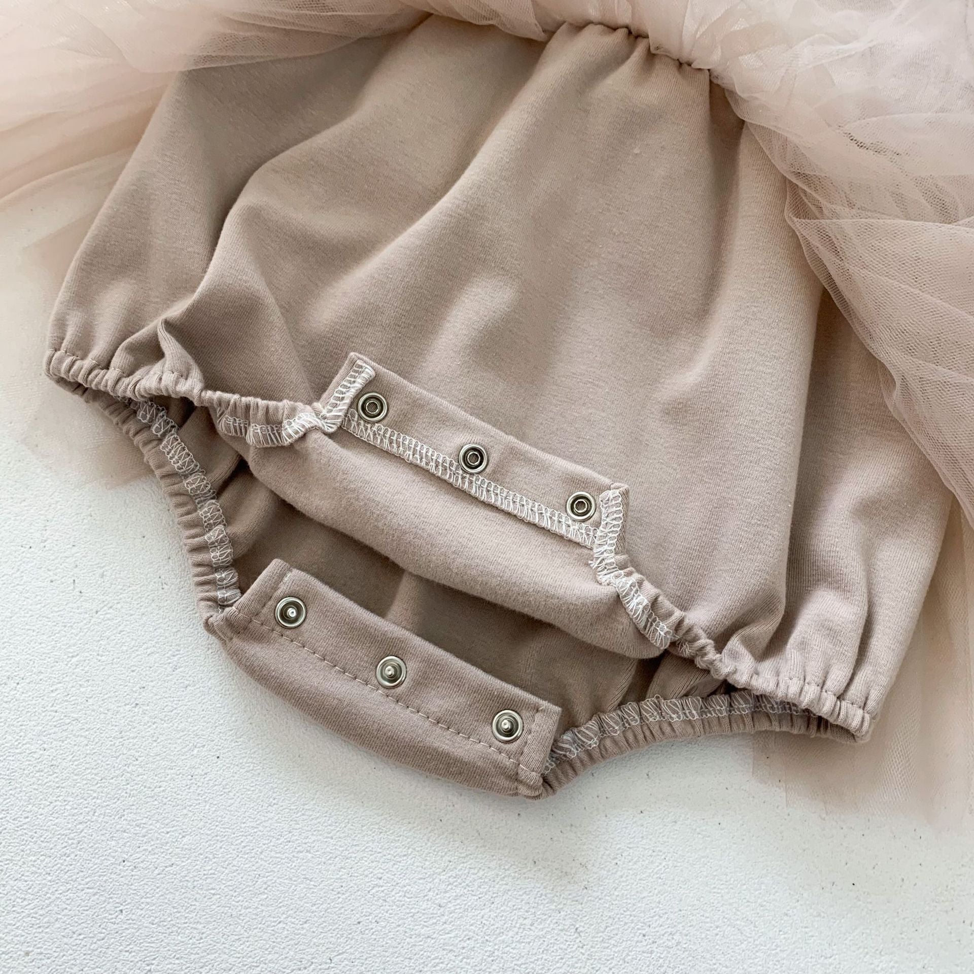 Baby girls' lace patchwork bubble dress in white with long sleeves, showcasing delicate lace details and a comfortable fit.