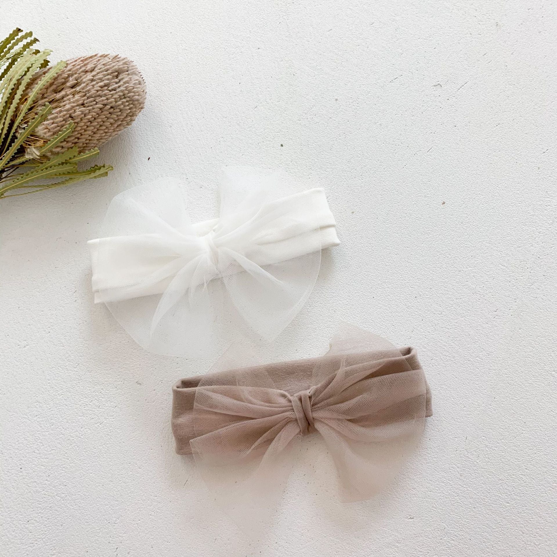 Baby girls' lace patchwork bubble dress in white with long sleeves, showcasing delicate lace details and a comfortable fit.