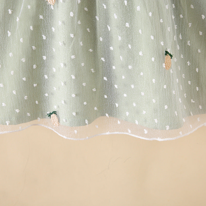 Baby girls dress featuring pineapple embroidery, polka dot lace patchwork, and square collar in vibrant green color.