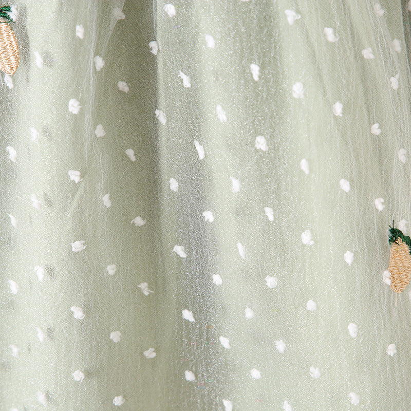 Baby girls dress featuring pineapple embroidery, polka dot lace patchwork, and square collar in vibrant green color.