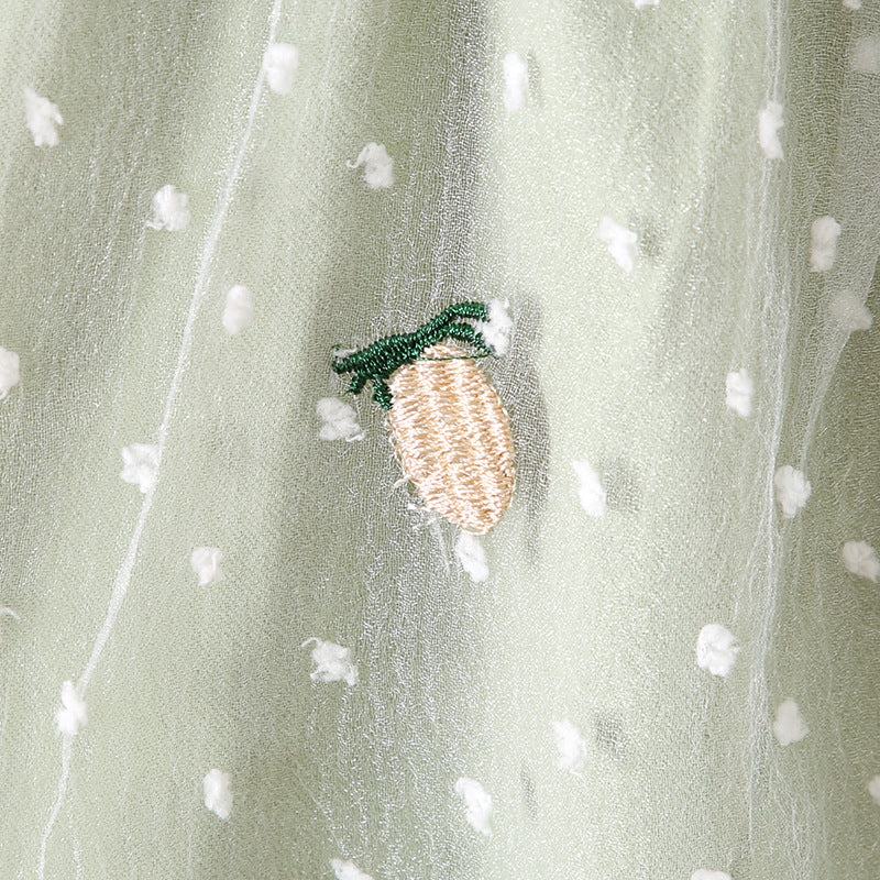 Baby girls dress featuring pineapple embroidery, polka dot lace patchwork, and square collar in vibrant green color.