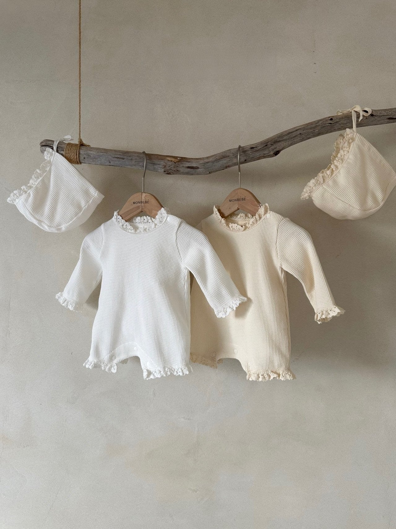 Baby girls' long sleeves onesie in waffle design with lace collar, available in white and apricot colors.