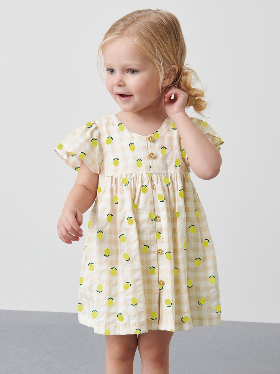 A bright yellow plaid dress for baby girls featuring short sleeves and a lemon print, perfect for summer wear.
