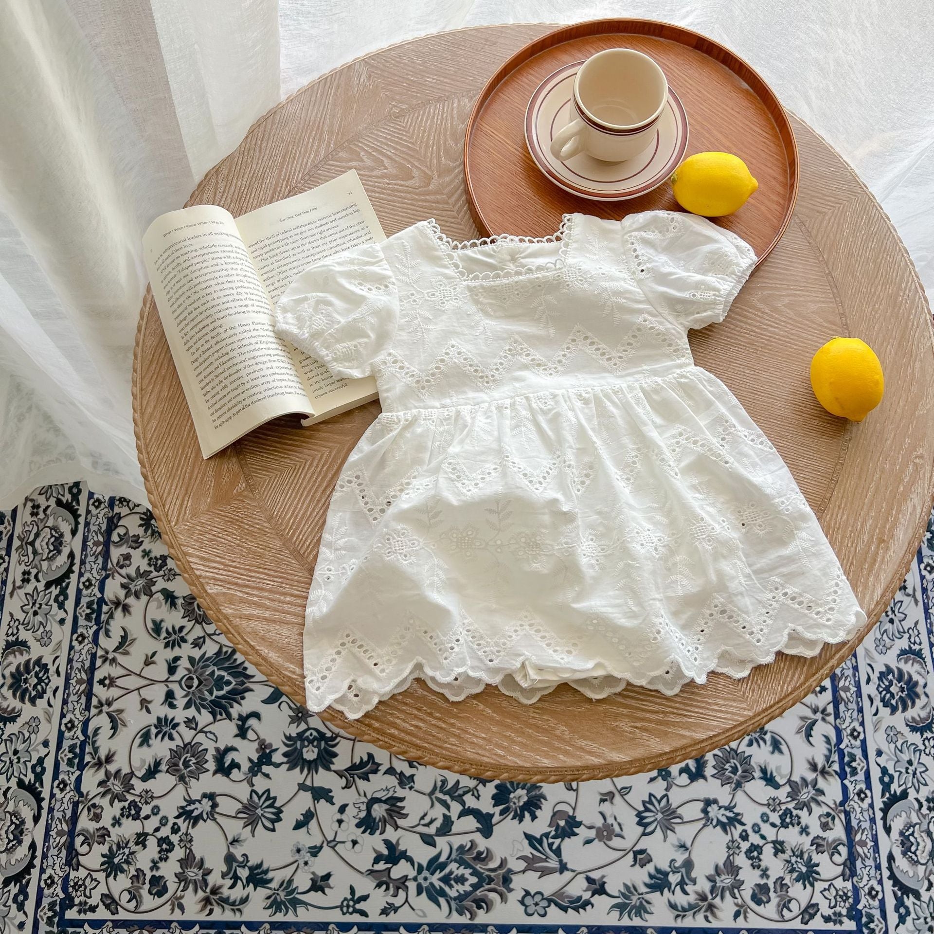 Baby girls' short-sleeved dress featuring a square neck and hollow-carved design in solid white color, made from soft cotton material.