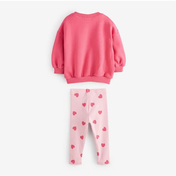 A pink baby hoodie set featuring a heart print pattern, perfect for girls aged 12 months to 10 years.