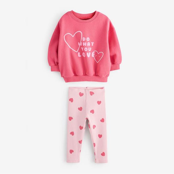 A pink baby hoodie set featuring a heart print pattern, perfect for girls aged 12 months to 10 years.