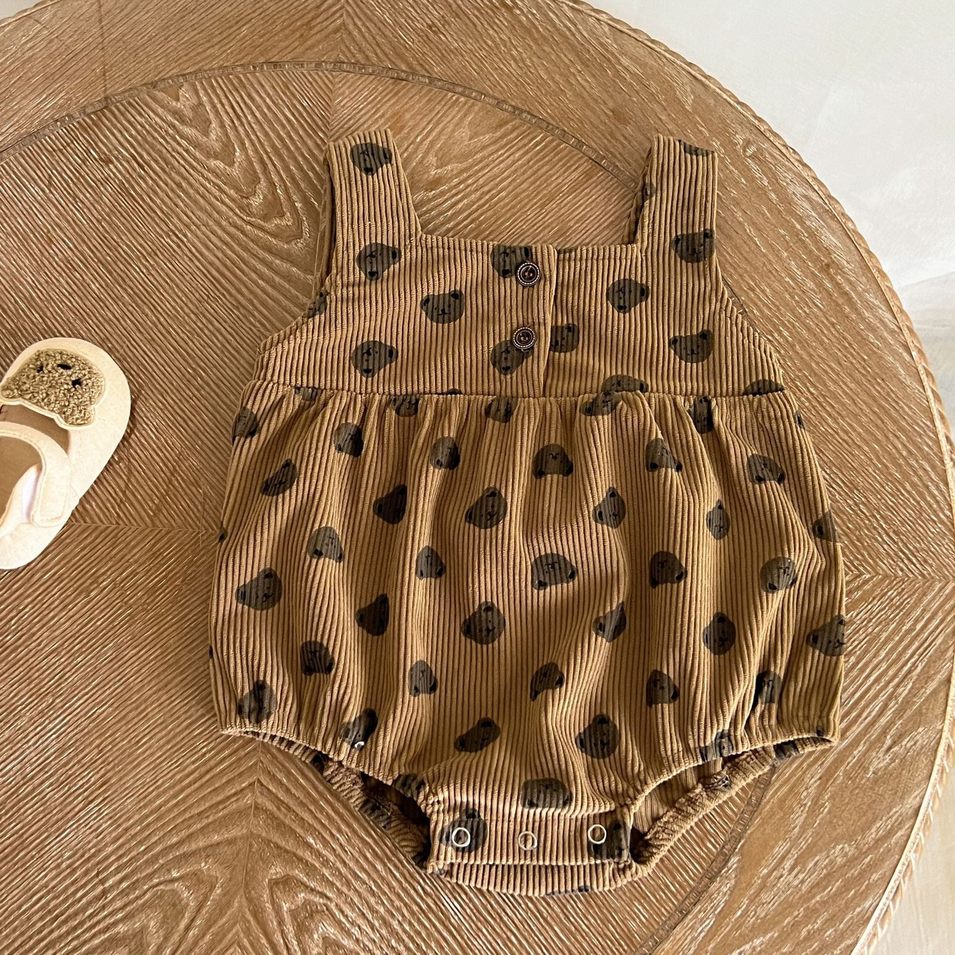 Baby Heart Print Pattern Strap Design Triangle Onesies in beige and brown, showcasing intricate heart patterns and stylish straps.