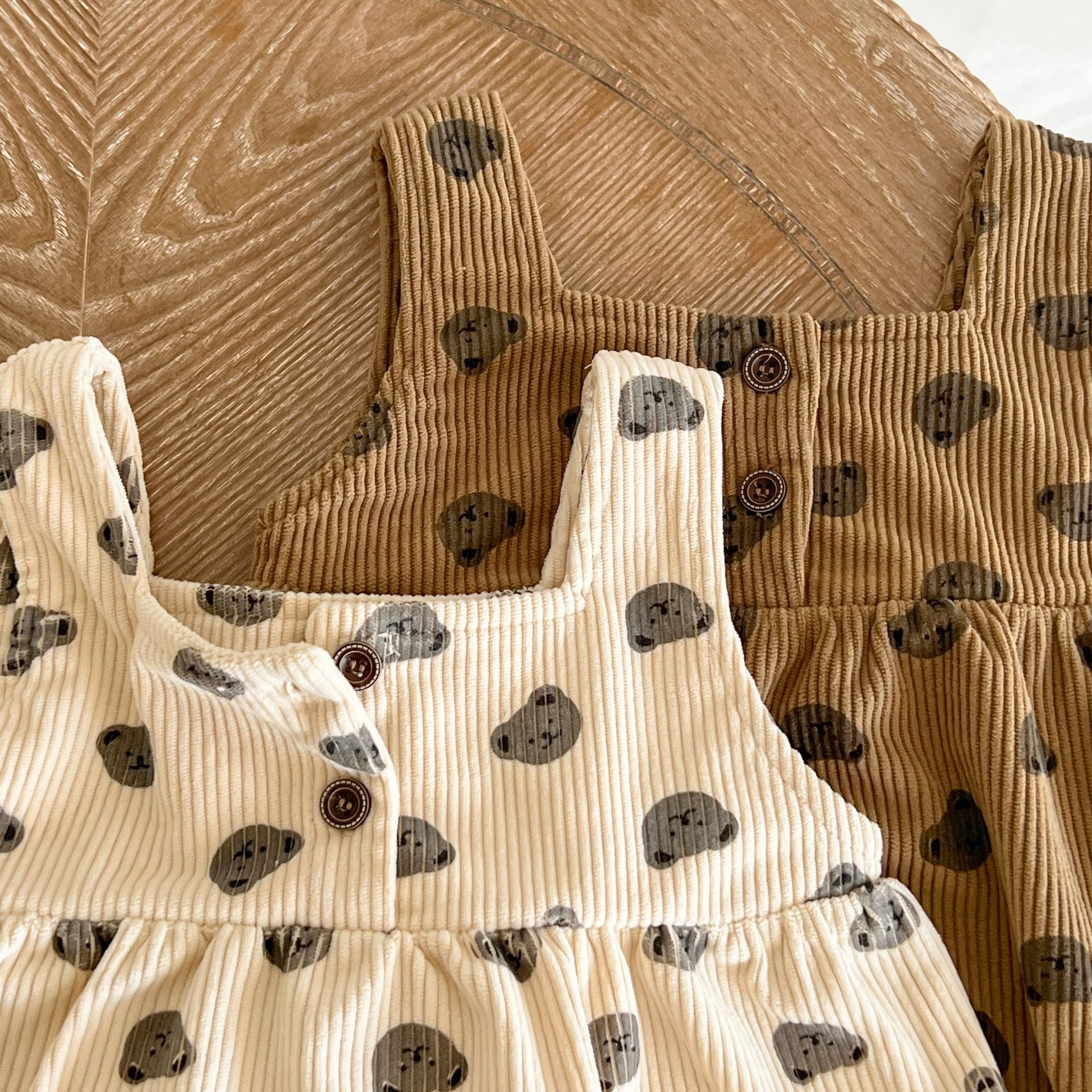 Baby Heart Print Pattern Strap Design Triangle Onesies in beige and brown, showcasing intricate heart patterns and stylish straps.
