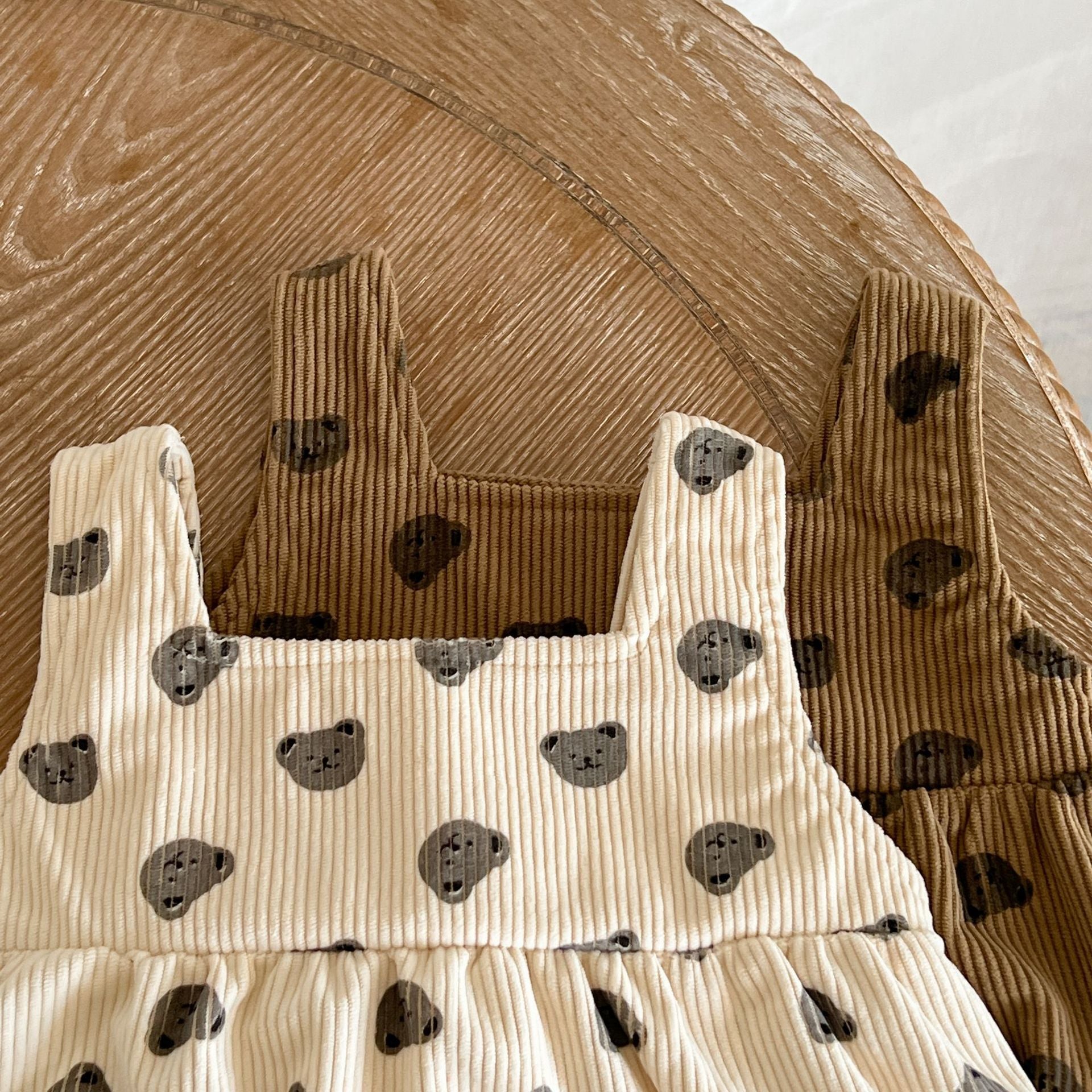 Baby Heart Print Pattern Strap Design Triangle Onesies in beige and brown, showcasing intricate heart patterns and stylish straps.