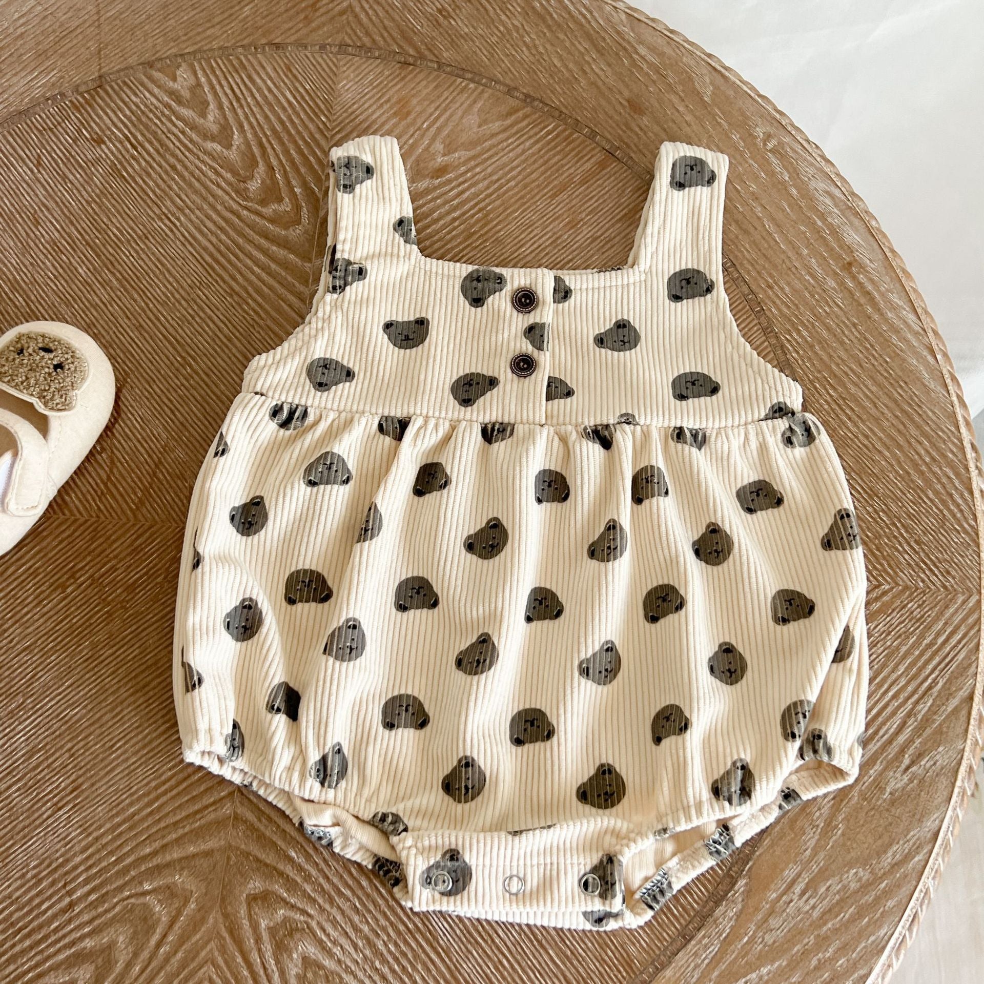 Baby Heart Print Pattern Strap Design Triangle Onesies in beige and brown, showcasing intricate heart patterns and stylish straps.