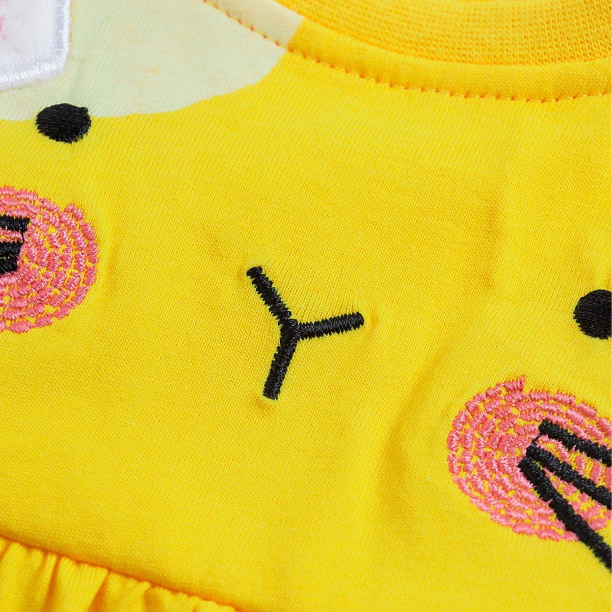 A bright yellow baby dress featuring a cute rabbit design and polka dots, perfect for summer wear.