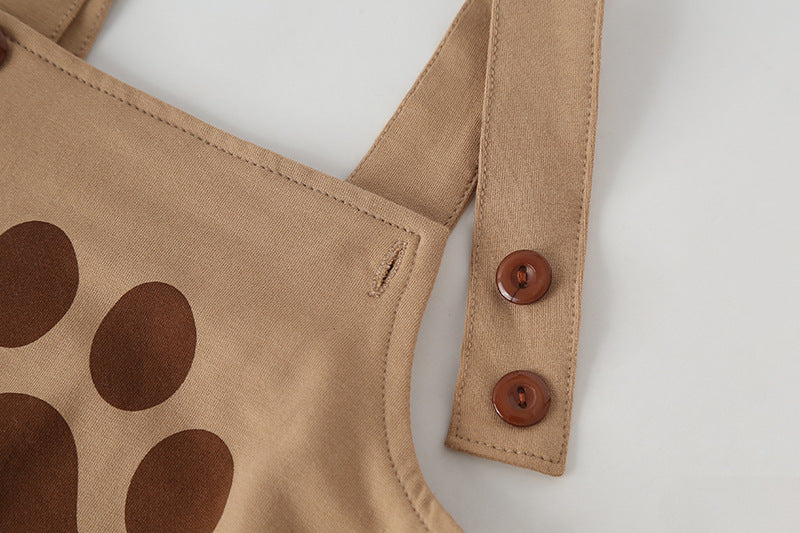 Adorable baby onesie set featuring a puppy print pattern, short sleeves, and straps, accompanied by a matching puppy-shaped hat.