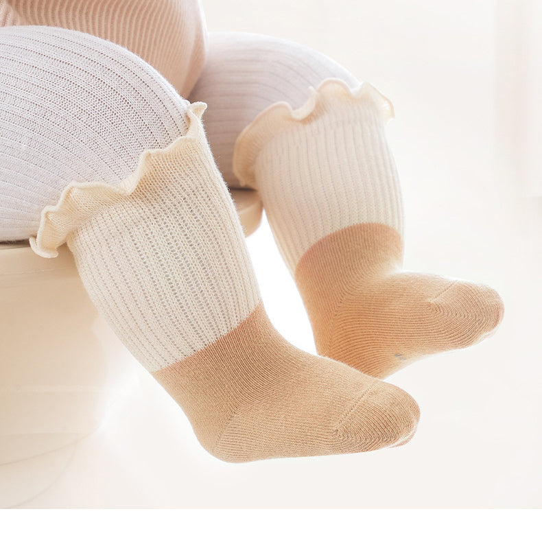 Colorful patchwork crew socks for babies and kids with ruffle fringe design, available in multiple colors.