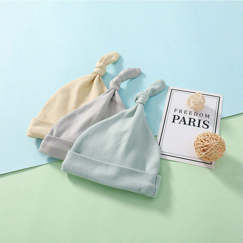 A colorful baby pullover long tail hat made of soft cotton, featuring a vibrant design suitable for both baby boys and girls.