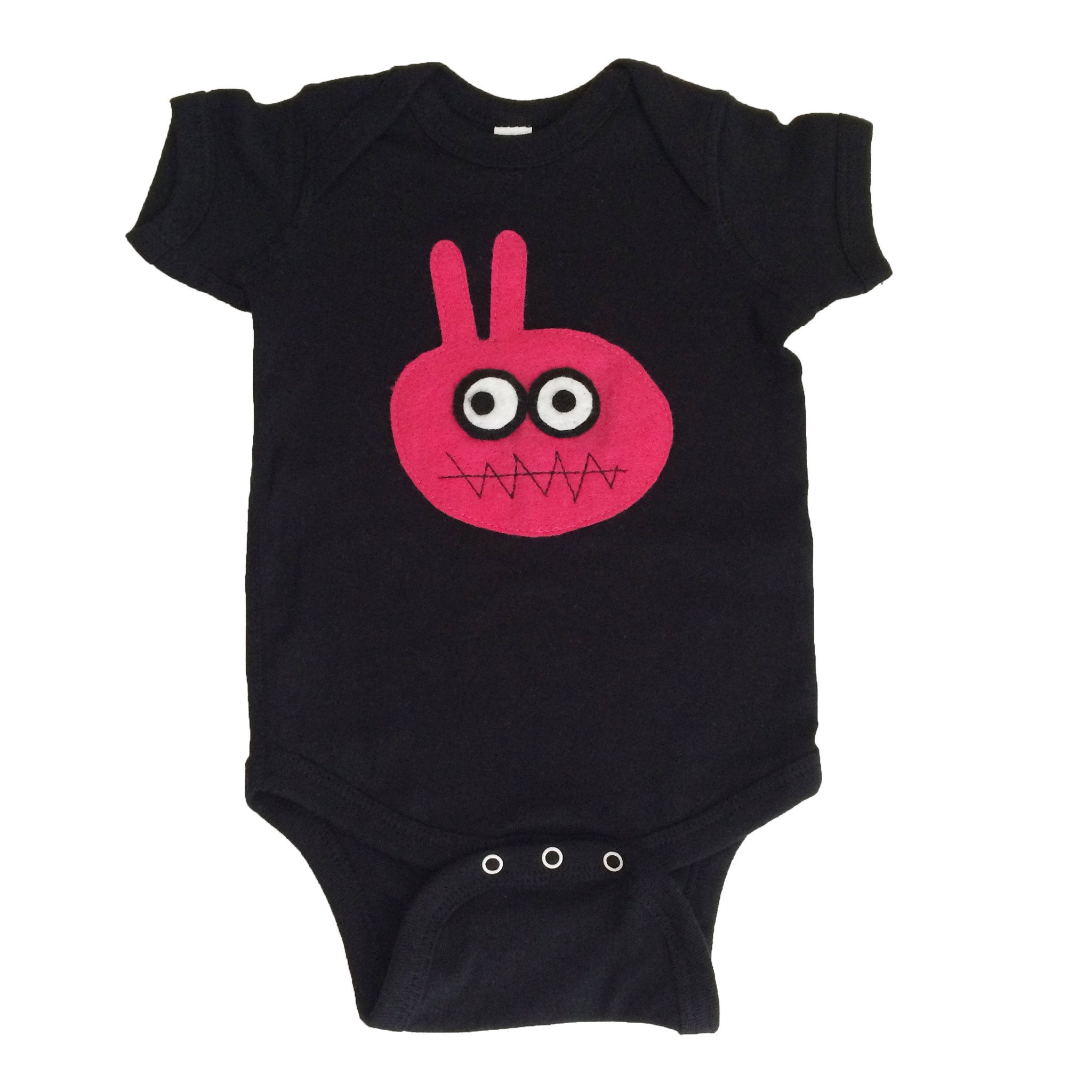 A handmade baby onesie featuring a cute bunny design, crafted with love by mi cielo in collaboration with Matthew Langille, showcasing felt appliqué details.