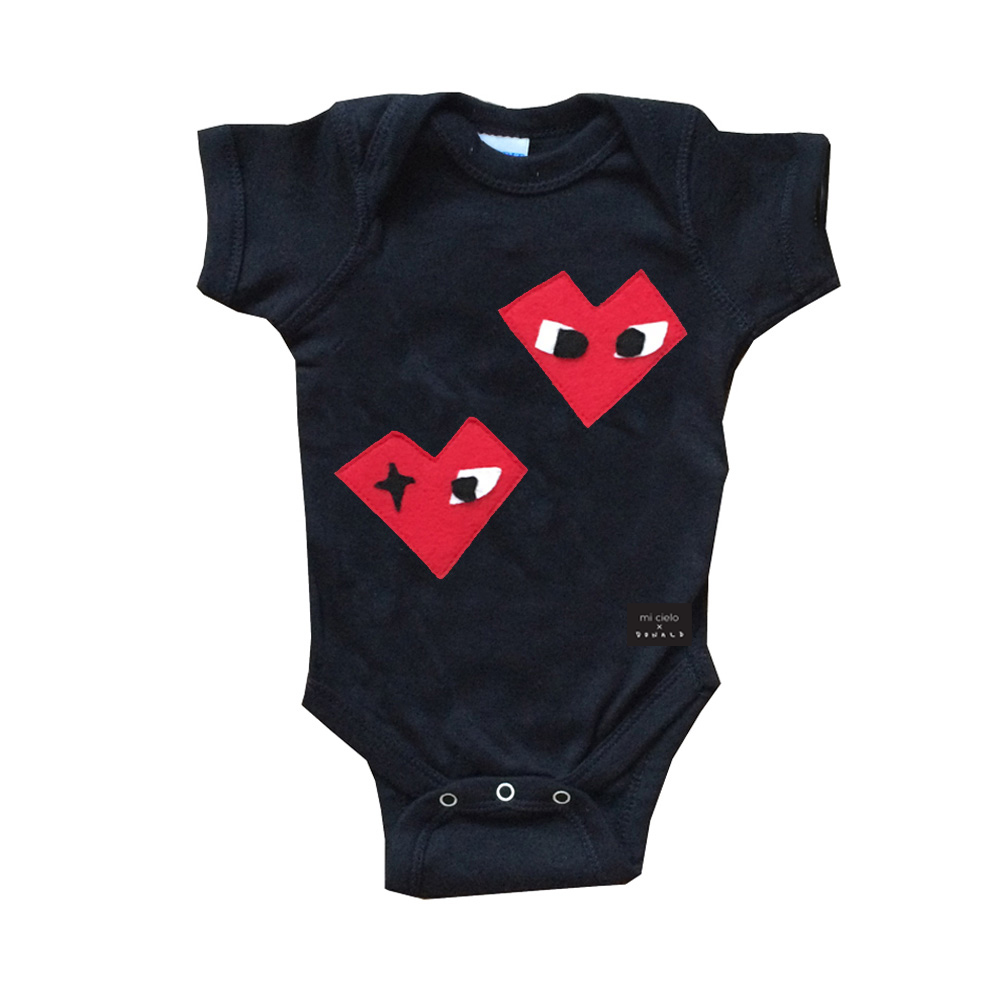 Black baby onesie featuring 'I Heart' design by mi cielo and Donald Robertson, handmade with felt appliqué.