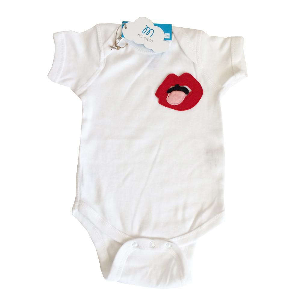 Handmade Baby Onesie featuring a playful lips design, crafted by mi cielo in collaboration with Donald Robertson, showcasing vibrant colors and unique felt appliqué.
