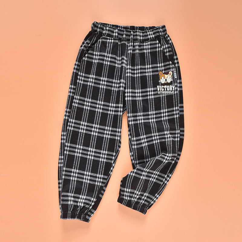 Baby plaid and cartoon animal print loose trousers in black, showcasing playful patterns and comfortable fit for children.