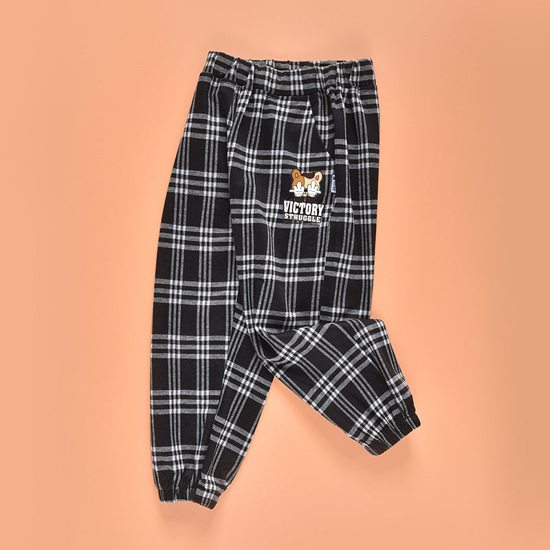 Baby plaid and cartoon animal print loose trousers in black, showcasing playful patterns and comfortable fit for children.