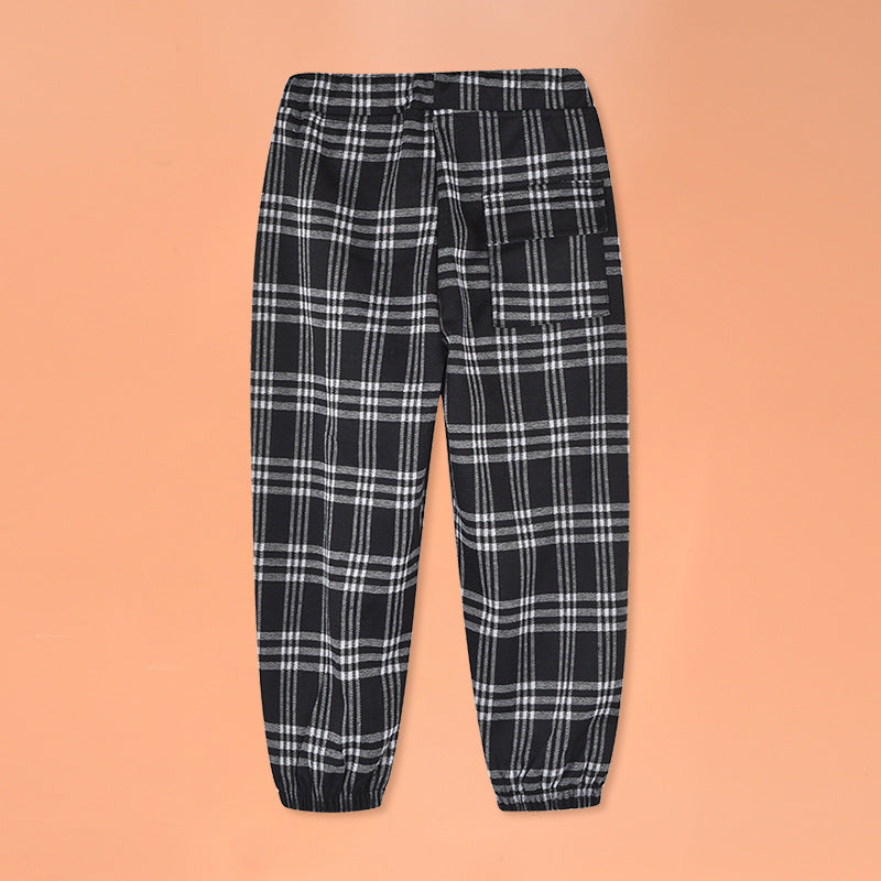 Baby plaid and cartoon animal print loose trousers in black, showcasing playful patterns and comfortable fit for children.