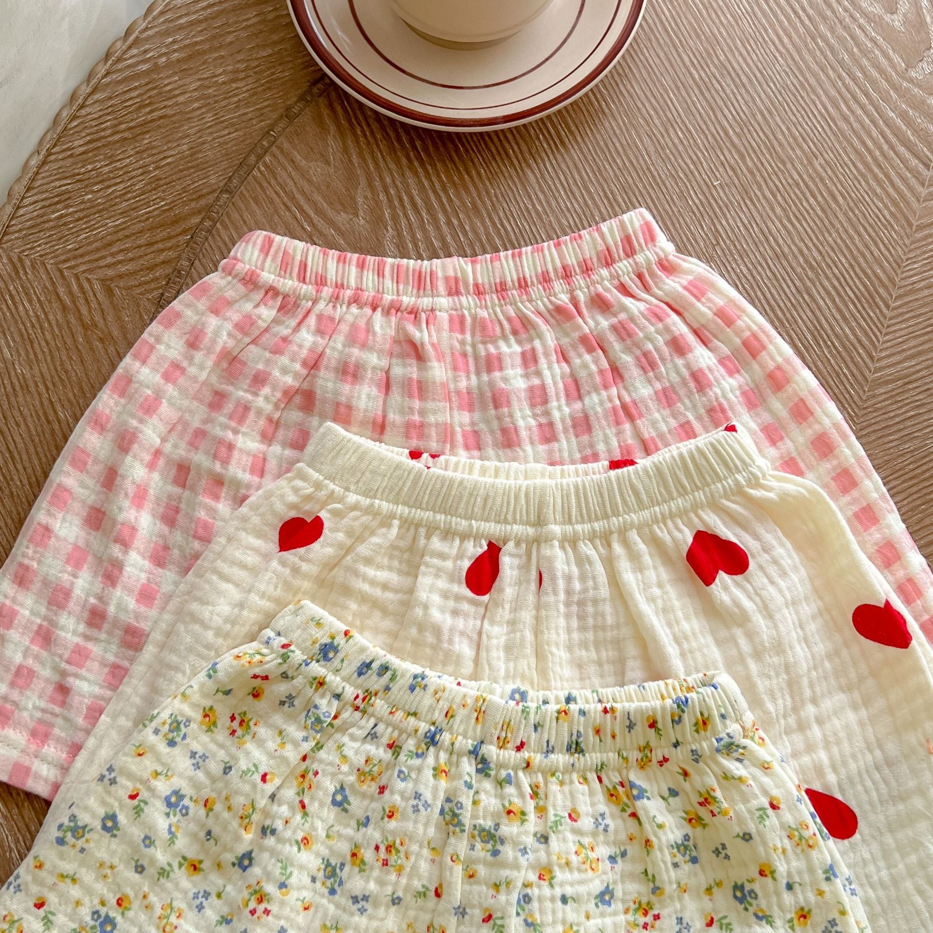 A colorful baby summer outfit featuring a print pattern t-shirt and combo shorts, perfect for keeping little ones cool and stylish.
